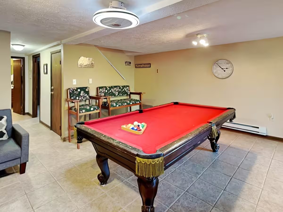 Game room at the first stay with a red felt pool table.