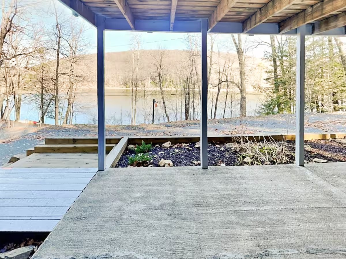 Covered patio at the first stay looking through trees toward Deep Creek Lake.